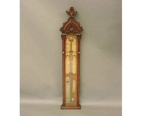 An Admiral Fitzroy barometer, the oak case carved with a Gothic arch and foliage, 127cm tall
