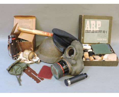 A selection of militaria, to include tin hat, peaked cap, army 15506 gas mask, ARP medical kit, etc