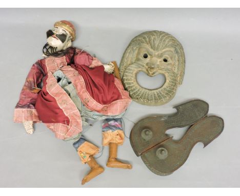 A pair of Persian wooden sandals, an Indian carved wooden puppet, with articulated hands, 54cm high, and a 'Roma' pottery mas