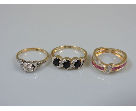 A single stone diamond ring, marked 18ct plat, a 9ct gold three stone sapphire ring with a diamond set ribbon, and a 9ct gold