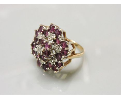 A 9ct gold illusion set diamond and ruby cluster ring