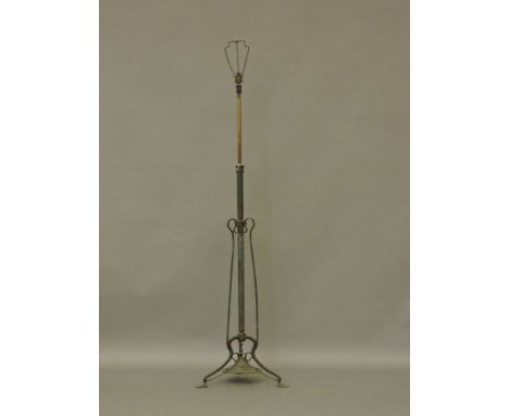 An Art Nouveau telescopic standard lamp, and an oval wall mirror