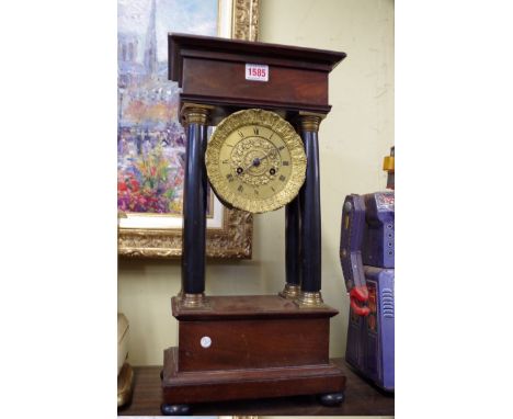 A 19th century Continental mahogany and ebonized portico style clock,&nbsp;47.5cm high. 