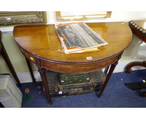 A George III mahogany, line inlaid and crossbanded demi-lune card table,&nbsp;with double gateleg action, 99cm wide.&nbsp; 