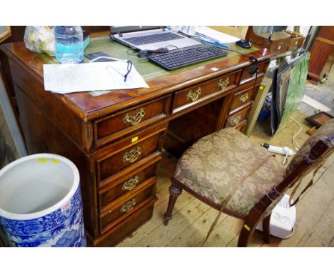 A reproduction figured walnut pedestal desk, 124cm wide. 
