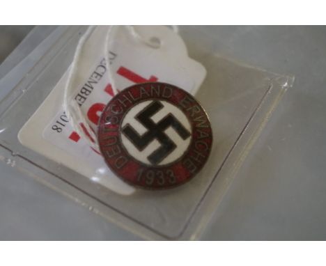 A World War II German National Socialist Party enamel badge, marked RZM M1/129. 