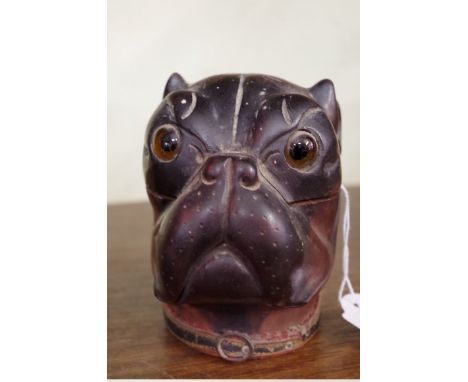 A 19th century carved and stained wood novelty dog's head inkwell,&nbsp;with glass eyes, 11cm high.&nbsp; 