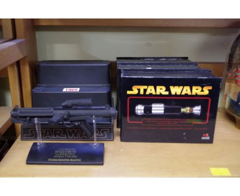 Three 'Master Replicas' Star Wars .45 scale lightsabers,&nbsp;each boxed, with display stand; together with a similar Stormtr