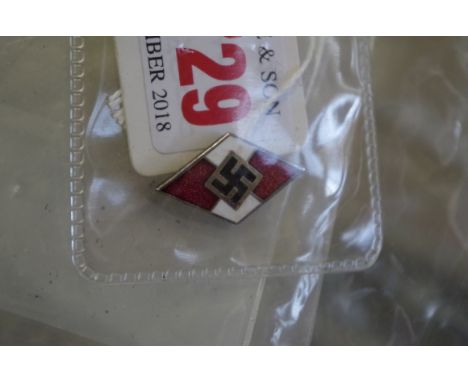 A World War II German Hitler Youth enamel badge, marked REM M1/52. 