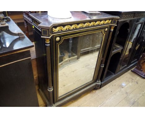 A late 19th century ebonized and brass pier cabinet, with mirror panel door, 83.5cm wide. &nbsp; 