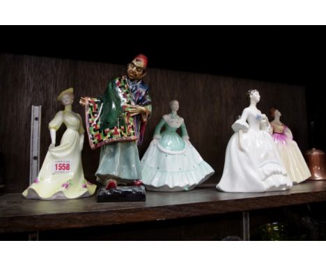 A Royal Doulton figure of 'The Carpet Seller',&nbsp;HN1464, (chip to right hand); together with another Royal Doulton figure;