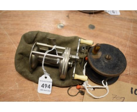 A Pflueger Buckeye cross-wind spinning reel and a small vintage fly reel