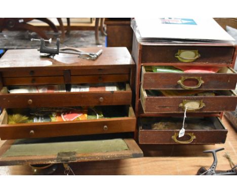 A wooden tool chest and a set of small draws packed with fly making tools and equipment