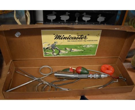 A boxed vintage 'Minicaster' coiled spring fishing rod original box