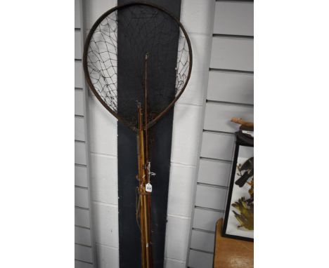 A vintage unmarked fly rod with spare tip a landing net and some split cane rod pieces