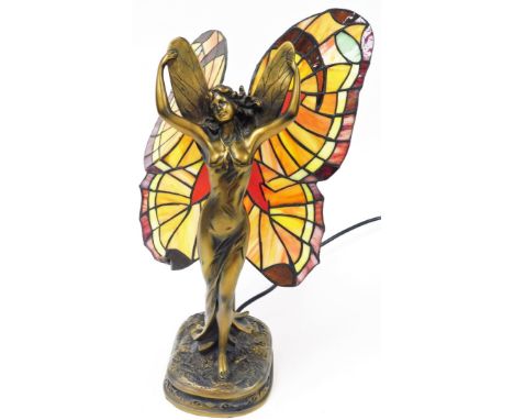 A Tiffany style fairy lamp, the figure in standing pose, with decorative glass wings, on a shaped base, 41cm high. 