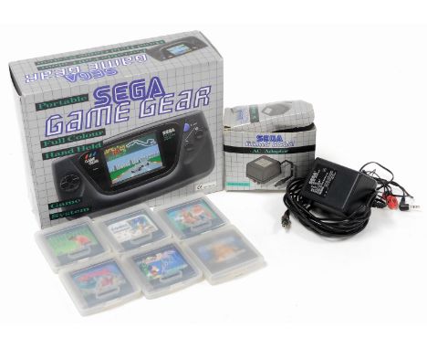 A boxed Sega Game Gear games console, with boxed AC adapter, quantity of games in outer game gear plastic boxes, to include W