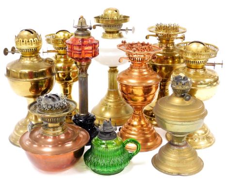 Various brass and other lamp bases, one with red moulded glass reservoir and reeded stem, 33cm high, other brass lamp bases, 