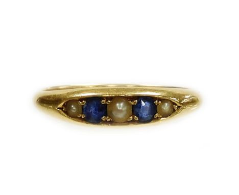 An 18ct gold sapphire and seed pearl marquise ring, set with two round brilliant cut sapphires and three seed pearls, ring si