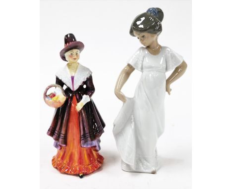 Two porcelain figures, to include a Nao figure of a girl with fraying dress 22cm high and a Royal Doulton style figure of a l