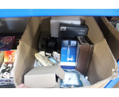 A box containing decorative mantel clock; a wall clock; a BT telephone; hairdryer etc