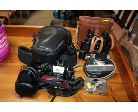 A Contax camera; a Konica camera; a Canon camera and a pair of binoculars