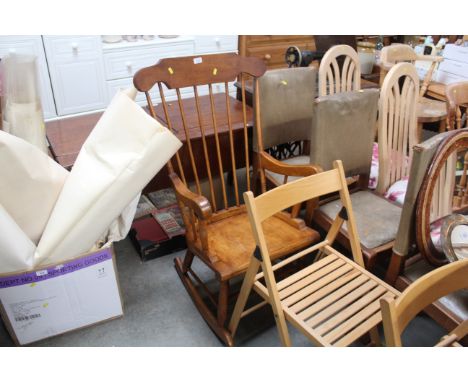 A stained pine stick back rocking chair