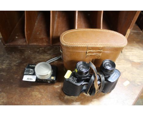 A Panasonic DMC LX1 digital camera and a pair of Green Kat 8 x 30 binoculars with carrying case