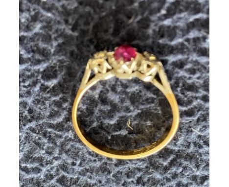 Yellow metal ring with ruby flanked by diamonds Size O - P 2.5 g