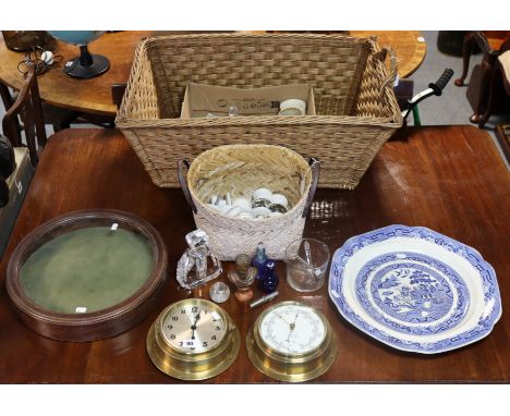 A brass-cased ship’s bulkhead time piece; a ditto barometer, both 18cm diameter; a wicker basket; a wooden display case, 40.5