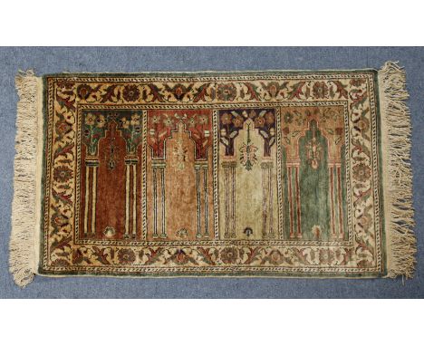 A vintage Turkish Kayseri small rug with central garden design in a floral border, 114cm x 61cm