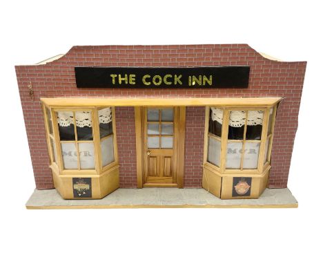 Scratch-built illuminated wooden doll's house type display of 'The Cock Inn' public house, the hinged front opening to reveal