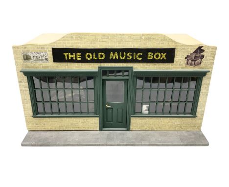 Scratch-built illuminated wooden doll's house type display of 'The Old Music Box' music shop, the hinged front opening to rev