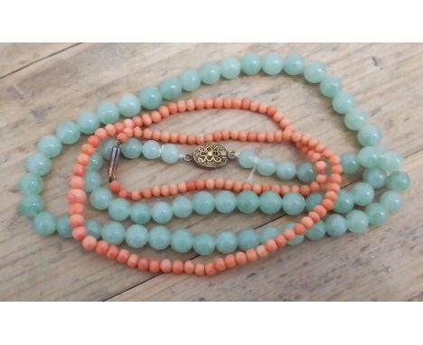 A jadeite jade bead necklace and a coral necklace with clasp marked '9c'.  