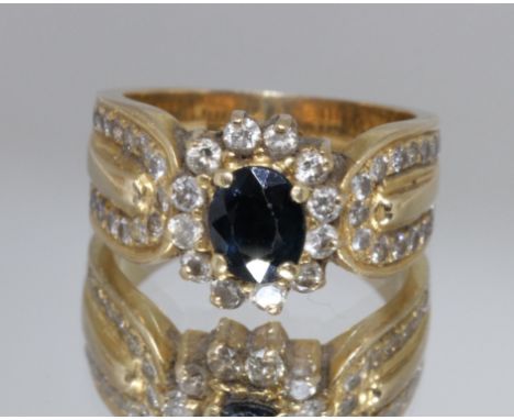 A sapphire and diamond cluster ring, unmarked, band split, gross weight 7.5g, size K.  