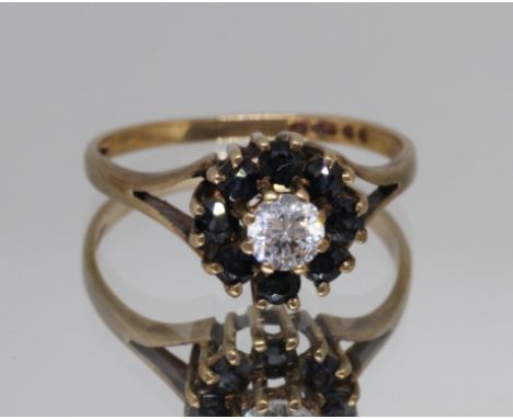 A hallmarked 9ct gold sapphire and colourless stone cluster ring, gross weight 1.9g, size K.  