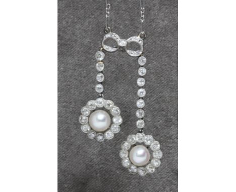 An early 20th century diamond and cultured pearl negligee necklace, the two drops with central pearl surround by millegrain b