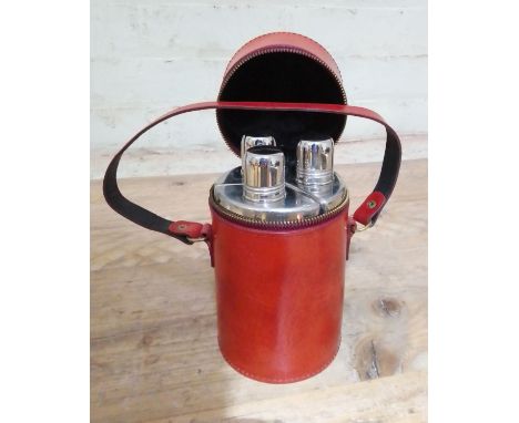 A vintage leather cased set of three travel flasks.  