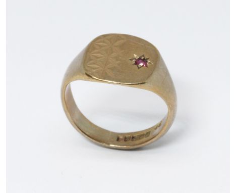 A hallmarked 9ct gold signet ring set with a ruby, gross weight 5.4g, size M.  