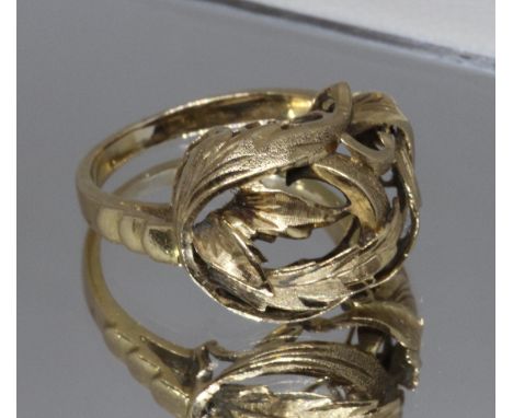 A yellow metal ring, the head formed from entwined leaves, indistinct foreign mark, weight 4.5g, size K.  