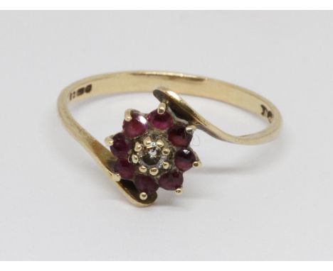 A hallmarked 9ct gold diamond and ruby ring, gross weight 1.3g, size M.  