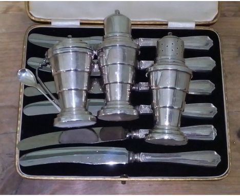 A 1930s vintage art deco silver cruet set, Davenport 1937 and a set of silver handled knives by Viner's 1939.  