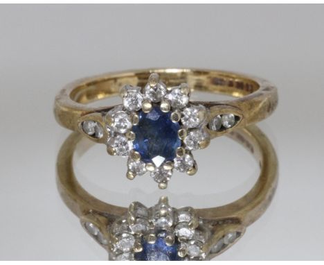 A hallmarked 9ct gold diamond and sapphire cluster ring, gross weight 3g, size K.  
