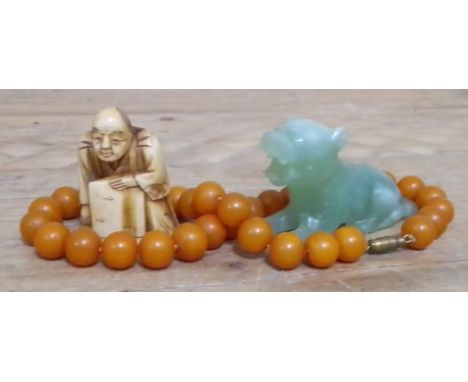 A bone netsuke, a jadeite jad carving and a bead necklace.  