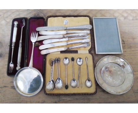 A mixed lot of hallmarked silver comprising a set of four dog finial spoons, silver handled knives, a silver handled and blad