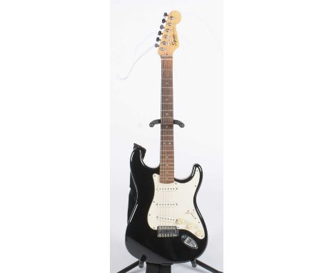 A Fender Squier SRAT, with maple and rosewood neck, black finish with three single-coil pickups.