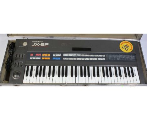 A mid 1980's Roland JX-8P Midi polyphonic synthesizer with power lead and foot pedal, owner's manual, in-flight case.