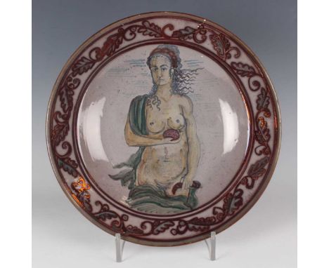 An Italian pottery lustre charger, early 20th century, painted with a three-quarter-length study of a female nude, probably V