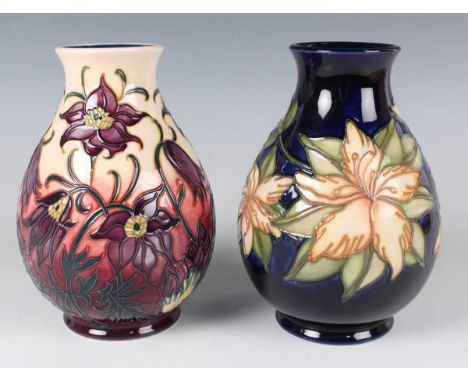Two Moorcroft Pottery vases, the first in the Pasque Flower pattern, dated 2002, designed by Philip Gibson, the second a trai