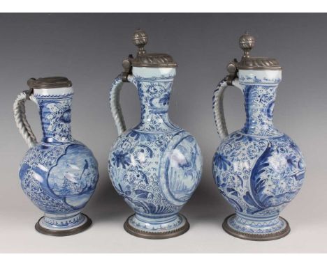 Two South German faience pewter mounted jugs (Enghalskrug), late 17th/18th century, with spiral moulded bodies painted in blu